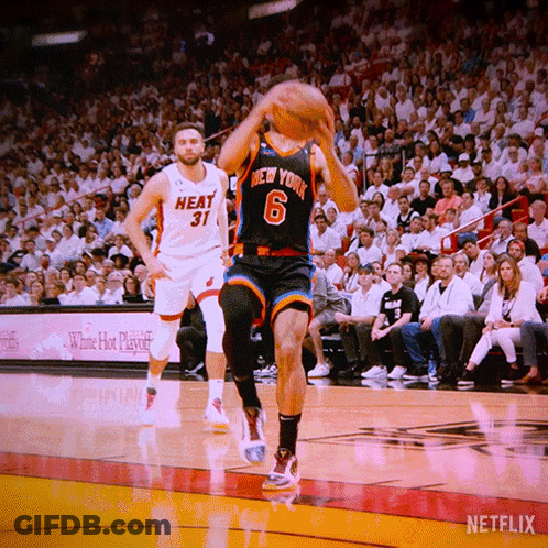 A Basketball Player Wearing A New York Jersey Is Jumping To Catch The Ball GIF