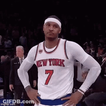 A Basketball Player Wearing A New York Jersey Is Standing With His Hands On His Hips On A Court . GIF