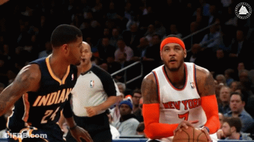 A Basketball Player Wearing A New York Jersey Looks At Another Player GIF