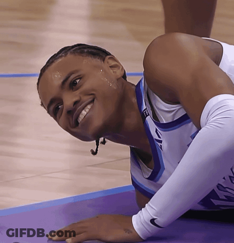 A Basketball Player Wearing A Nike Sleeve Is Smiling On The Court GIF