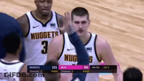 A Basketball Player Wearing A Nuggets Jersey Gives A High Five GIF
