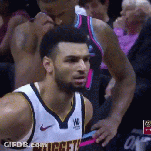 A Basketball Player Wearing A Nuggets Jersey Looks At The Camera GIF