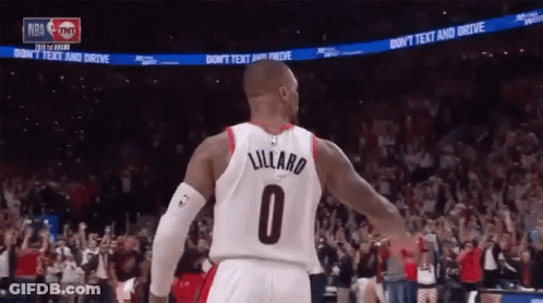 A Basketball Player Wearing A Number 0 Jersey Stands In Front Of A Crowd GIF