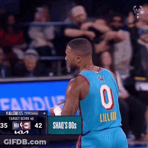 A Basketball Player Wearing A Number 0 Jersey Stands In Front Of A Scoreboard GIF