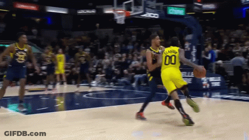 A Basketball Player Wearing A Number 00 Jersey Dribbles The Ball GIF
