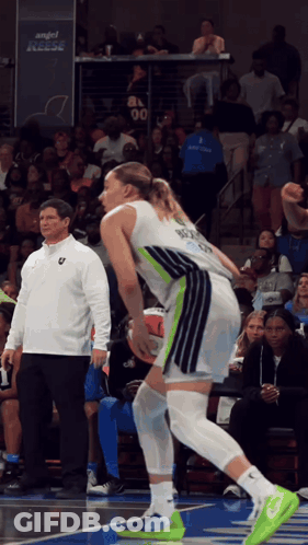 A Basketball Player Wearing A Number 00 Jersey Stands On The Court GIF