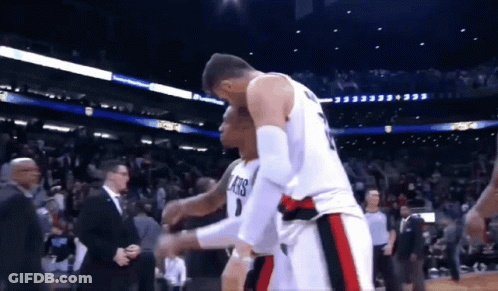 A Basketball Player Wearing A Number 1 Jersey Is Hugging Another Player GIF