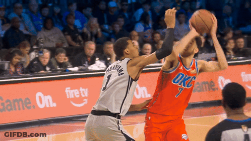 A Basketball Player Wearing A Number 1 Jersey Tries To Block Another Player GIF