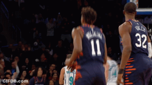 A Basketball Player Wearing A Number 11 Jersey Stands Next To A Player Wearing A Number 32 Jersey GIF