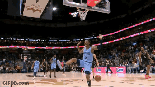 A Basketball Player Wearing A Number 12 Jersey Is Jumping In The Air GIF