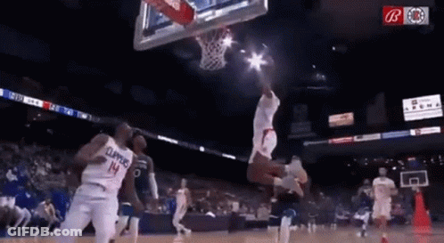 A Basketball Player Wearing A Number 14 Jersey Is Jumping In The Air While Playing Basketball . GIF