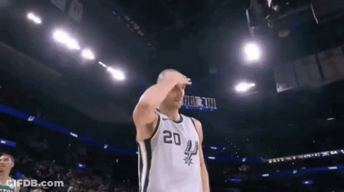A Basketball Player Wearing A Number 20 Jersey Salutes During A Game GIF