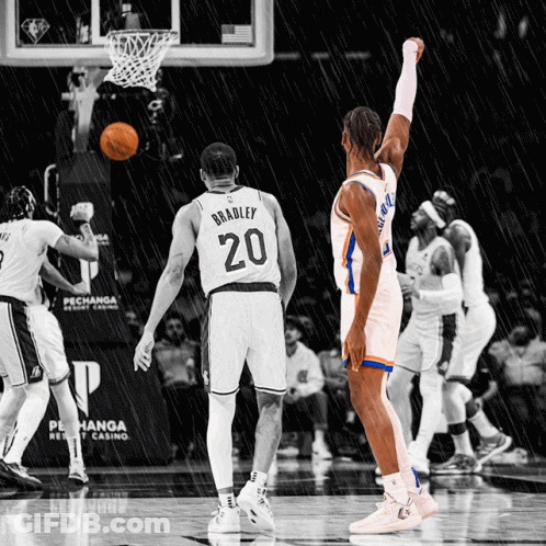 A Basketball Player Wearing A Number 20 Jersey Stands In The Rain GIF