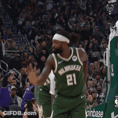 A Basketball Player Wearing A Number 21 Jersey GIF