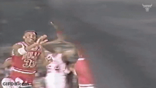 A Basketball Player Wearing A Number 23 Jersey Is Giving Another Player A High Five . GIF
