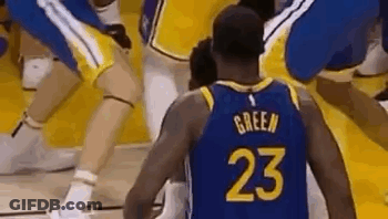A Basketball Player Wearing A Number 23 Jersey Is Standing On A Court Surrounded By Other Players . GIF