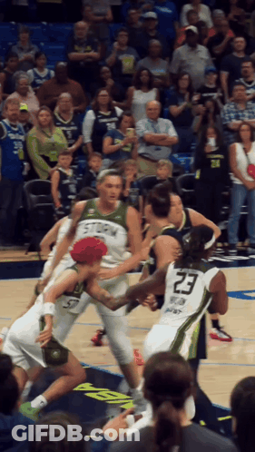 A Basketball Player Wearing A Number 23 Jersey Is Surrounded By Other Players GIF