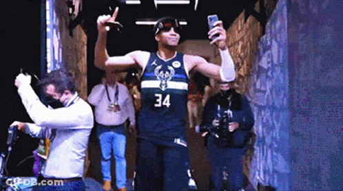 A Basketball Player Wearing A Number 34 Jersey Takes A Selfie GIF