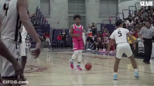 A Basketball Player Wearing A Number 5 Jersey Dribbles The Ball GIF