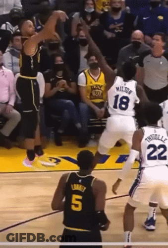 A Basketball Player Wearing A Number 5 Jersey Stands In Front Of A Player Wearing A Number 18 Jersey GIF