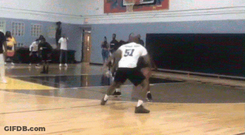 A Basketball Player Wearing A Number 51 Jersey Dribbles The Ball GIF