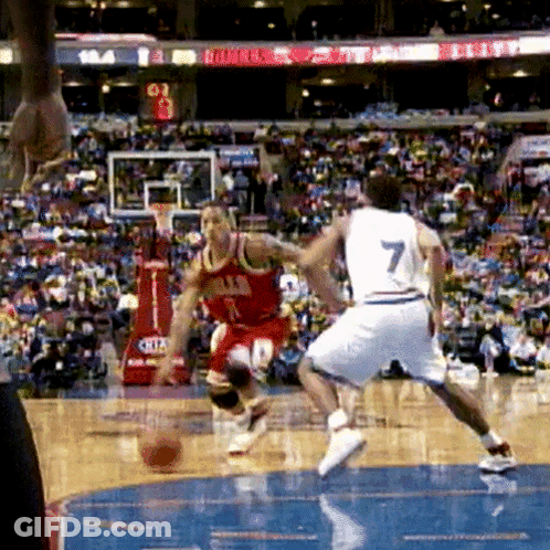 A Basketball Player Wearing A Number 7 Jersey Dribbles The Ball GIF
