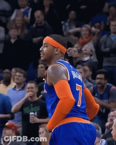 A Basketball Player Wearing A Number 7 Jersey Is Standing In Front Of A Crowd . GIF