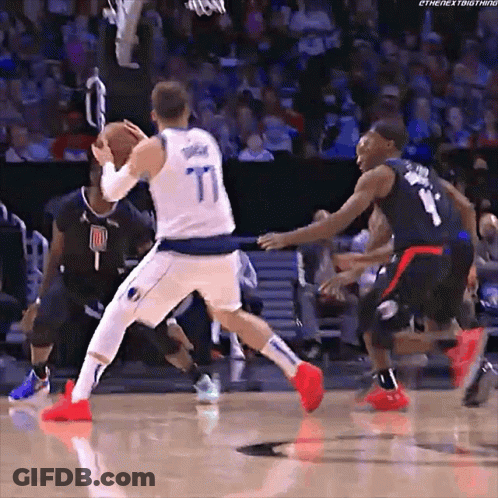 A Basketball Player Wearing A Number 77 Jersey Dribbles The Ball GIF
