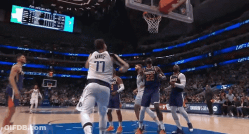 A Basketball Player Wearing A Number 77 Jersey Is Jumping In The Air GIF