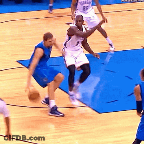 A Basketball Player Wearing A Number 9 Jersey Dribbles The Ball GIF