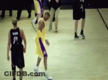 A Basketball Player Wearing A Number 9 Jersey Is Dribbling The Ball GIF