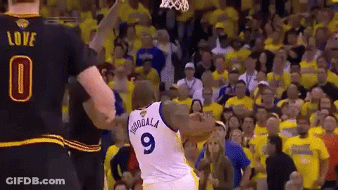 A Basketball Player Wearing A Number 9 Jersey Stands In Front Of A Crowd GIF