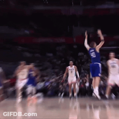 A Basketball Player Wearing A Number 90 Jersey Jumps In The Air GIF