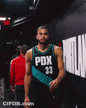 A Basketball Player Wearing A Pdx 33 Jersey Walks Down A Hallway GIF
