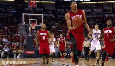 A Basketball Player Wearing A Pelican Jersey Is Jumping In The Air With The Ball GIF