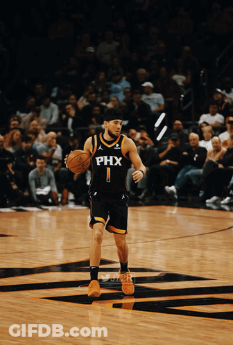 A Basketball Player Wearing A Phx Jersey Is Dribbling The Ball GIF