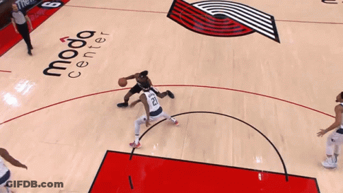 A Basketball Player Wearing A Portland Jersey Goes Up For A Shot GIF