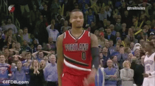 A Basketball Player Wearing A Portland Jersey Is Standing In Front Of A Crowd GIF