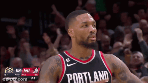 A Basketball Player Wearing A Portland Jersey Stands In Front Of The Crowd GIF