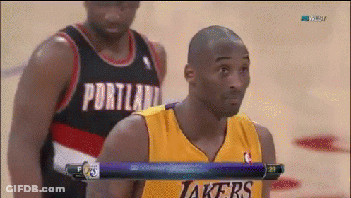 A Basketball Player Wearing A Portland Jersey Stands Next To Another Player Wearing A Yellow Lakers Jersey GIF