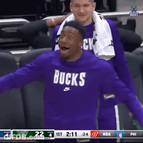 A Basketball Player Wearing A Purple Bucks Shirt GIF