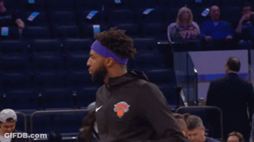 A Basketball Player Wearing A Purple Headband With The New York Knicks Logo GIF