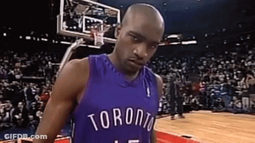 A Basketball Player Wearing A Purple Jersey Is Standing On A Basketball Court . GIF
