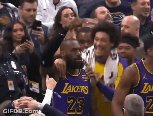 A Basketball Player Wearing A Purple Lakers Jersey Is Surrounded By Fans GIF
