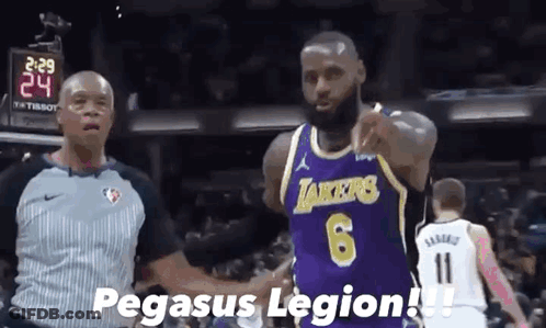 A Basketball Player Wearing A Purple Lakers Jersey Shakes Hands With A Referee During A Game . GIF