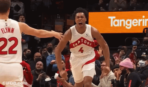 A Basketball Player Wearing A Raptors Jersey Celebrates GIF
