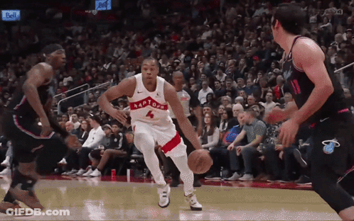 A Basketball Player Wearing A Raptors Jersey Dribbles The Ball GIF