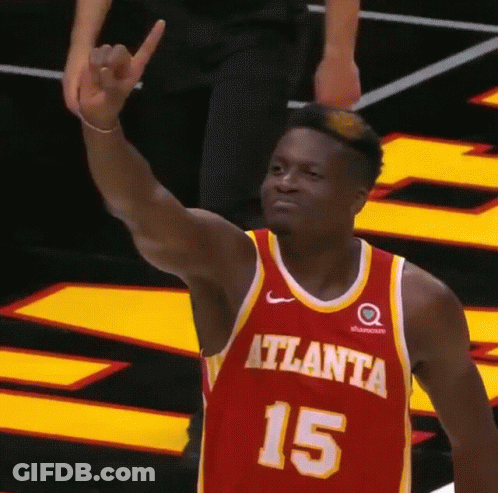 A Basketball Player Wearing A Red And Yellow Jersey With The Number 15 On It GIF