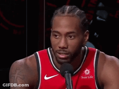 A Basketball Player Wearing A Red Jersey Is Smiling And Talking Into A Microphone . GIF