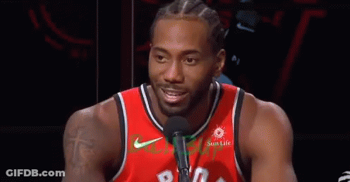 A Basketball Player Wearing A Red Jersey Is Talking Into A Microphone . GIF